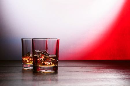 whiskey with ice in modern glassesの写真素材