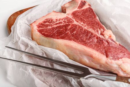 a piece of fresh farm meat t-bon non-GMO wrapped in eco-friendly wrapping paperの写真素材