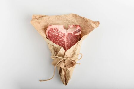 a piece of fresh farm meat t-bon non-GMO wrapped in eco-friendly wrapping paperの写真素材
