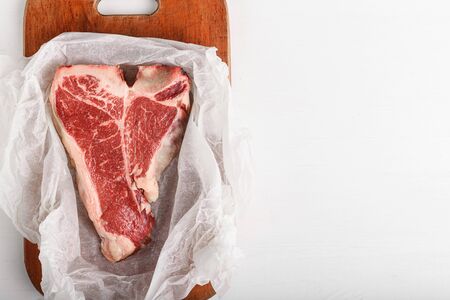 a piece of fresh farm meat t-bon non-GMO wrapped in eco-friendly wrapping paperの写真素材