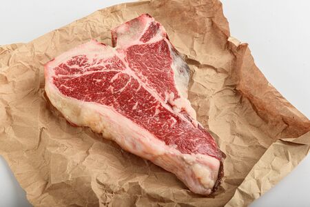 a piece of fresh farm meat t-bon non-GMO wrapped in eco-friendly wrapping paperの写真素材