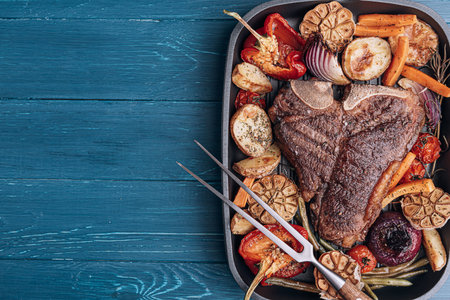 concept of a wonderful dinner for two of a delicious juicy fresh farmer marbled beef steak grilled...