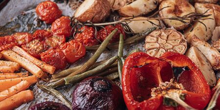 concept of a wonderful dinner for two of a delicious juicy fresh farmer marbled beef steak grilled with baked vegetablesの写真素材