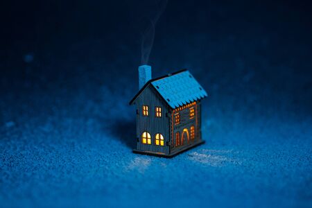 fabulous little house in the snow at nightの写真素材