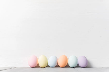 decorative easter eggs on a light wooden background. Easter-themed background with place for text