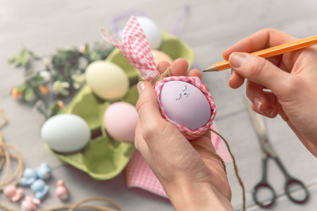 woman makes cute decorative eggs for easter holiday. do-it-yourself easter gifts concept. cute...
