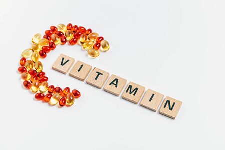letter C made from transparent pills near the inscription Vitamin on a white backgroundの写真素材