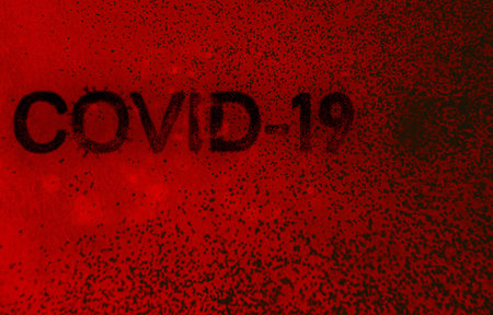 the inscription covid-19 made in the form of viruses and spores on a dark background