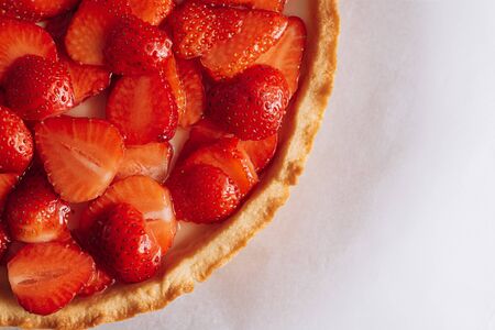 ingredients for strawberry pie, sliced strawberries laid on top of the pie and smeared with lime jelly on topの写真素材