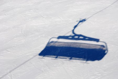 Shadow of ski lift on a white snowの写真素材