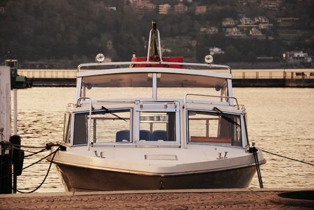 Vessel at a mooring in sunset light. Como lake in Lombardy, Italy.の写真素材