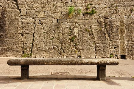 Stone bench against an old wall of castle in San Marino, Europe.の写真素材