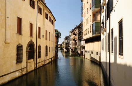 Narrow canal with row of houses in Padova, Italyの写真素材