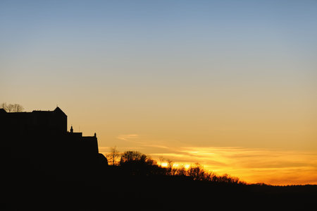 Evening skyline with castle in silhouette against sunset sky. There is plenty of room for text copy. Saxony, Germany.の写真素材