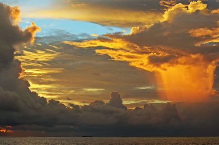 Fantastic sky (original colours) iluminated by the sunset light before the rain over the ocean. Maldives.の写真素材
