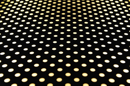 Abstract close up shot of metal mesh with light from insideの写真素材