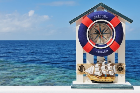 Sea theme - ship with watch souvenir against blue seaの写真素材