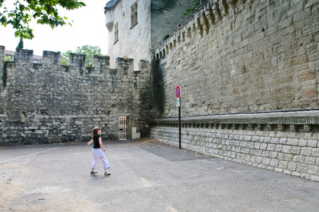 AVIGNON, FRANCE - JULY 7: girl plays with ball in medieval yard near walls of Pope Palace on July 7,2008 in Avignon, Franceのeditorial素材