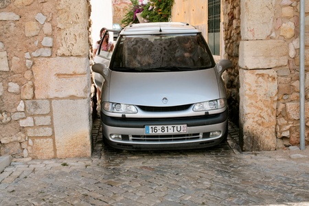 car on narrow street in medieval town in Faro, Portugal, on June 25, 2006のeditorial素材
