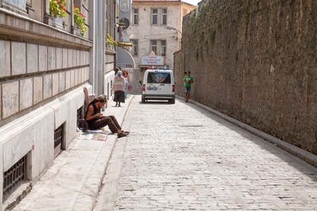 hippie man weaves whicky on town street on September 11,2010 in Istanbul, Turkeyのeditorial素材