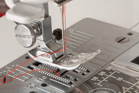 thread in needle of sewing machine closeup