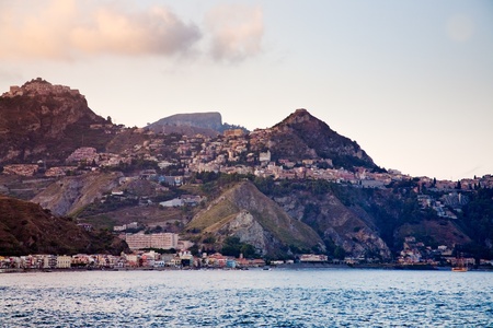 view on sicilian town Taormina on sunsetの写真素材