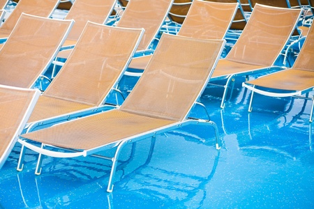 textile chairs on wet deck of cruise liner in rainy dayの写真素材