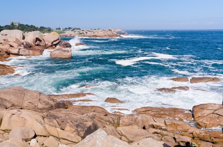 sea wave breaks against rocks on Pink Granite Coast in Breton Franceの写真素材