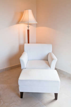 white leather chair and stand lamp in room cornerのeditorial素材