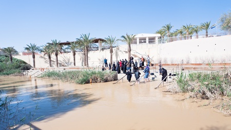 JORDAN RIVER, JORDAN - FEBRUARY,20:  Priests baptize people in Jesus Christ baptism site in Jordan River on February 20, 2012のeditorial素材