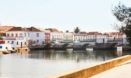 antique bridge through Gilao river in Tavira town, Portugalの写真素材