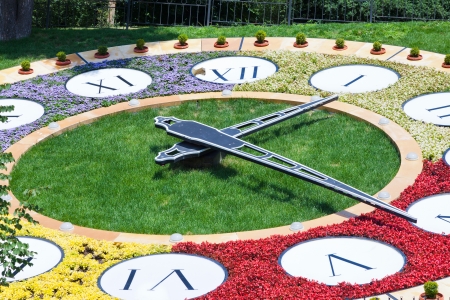 clock from flowers in urban parkの写真素材