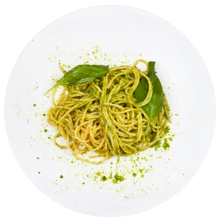 top view spaghetti mixed with pesto on plate isolated on white backgroundの写真素材