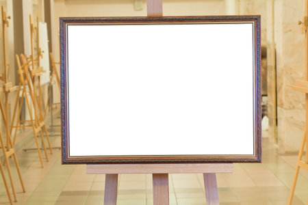 big picture frame with white cut out canvas on easel in art gallery