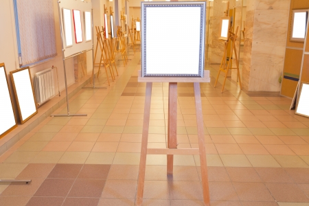 silver picture frame with white cut out canvas on easel in art gallery hallのeditorial素材
