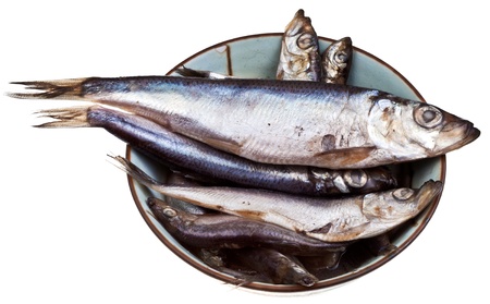 spicy salted sprats in ceramic bowl isolated on white backgroundの写真素材