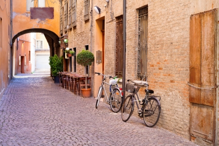 old small stone medieval street in historical center of Ferrara, Italyの写真素材