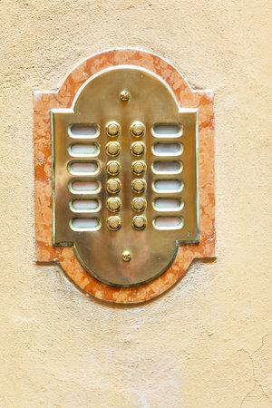 entrance door intercom on yellow house wall