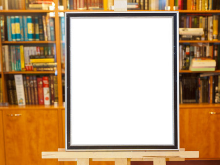 white canvas of picture frame on easel with clipping path and home library on background