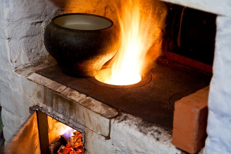 fire hearth of russian stove and old cast-iron potの写真素材