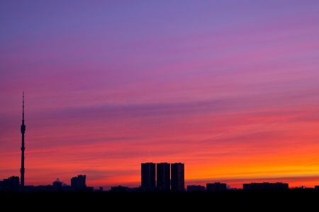 early pink sunrise colors under city with tv towerの写真素材