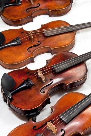 several used fiddles on white background close upの写真素材