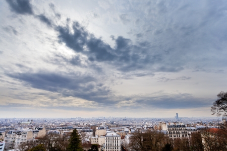 dark grey clouds under big city, Paris, Franceの写真素材