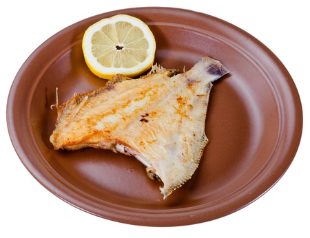 fried sole fish on brown plate isolated on white backgroundの写真素材