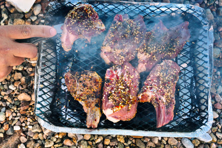 cooking barbecue from lamb chops on beachの写真素材