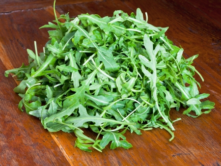 fresh arugula salad on wooden tableの写真素材