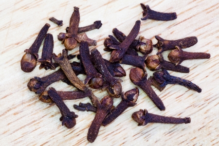 top view of dried clove buds on wooden boardの写真素材