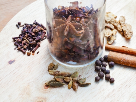 glass bottle with set of spices for mulled wine on wooden tableの写真素材