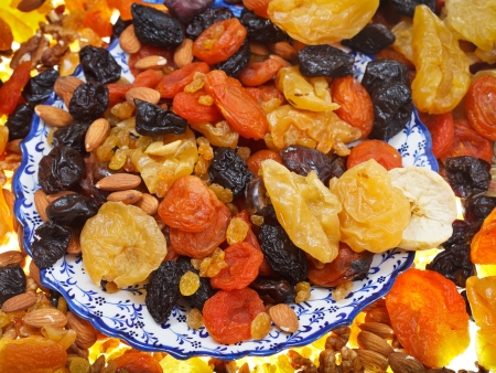 top view of oriental dessert - dried sweet fruits on arabic plate close upの写真素材