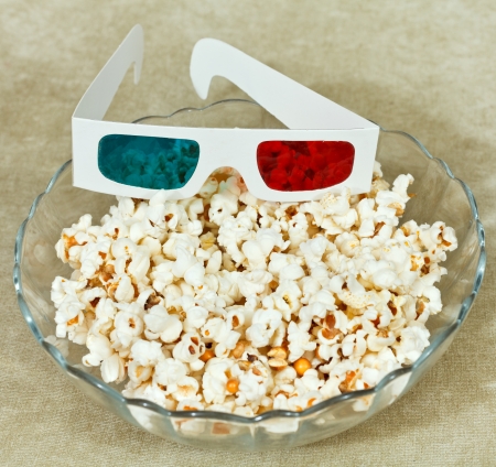 anaglyph 3D stereo glasses in bowl with popcornの写真素材